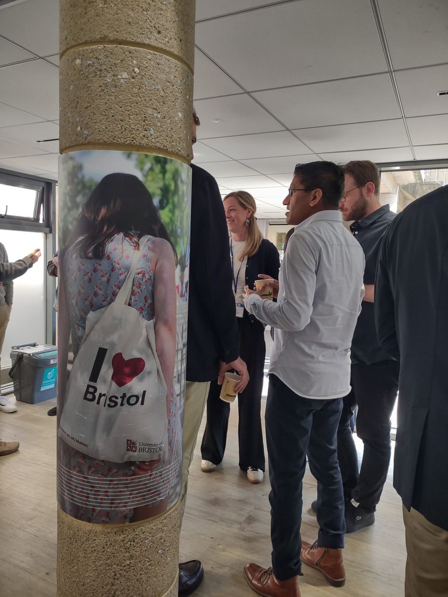 Participants of the BÆM 2025 development economics workshop chatting over coffee during a break